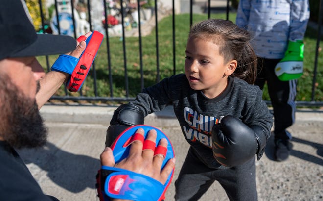 A young AVILA Victory Boxing member practices his punches during a training session outside a home garage in Greenfield on May 4th.