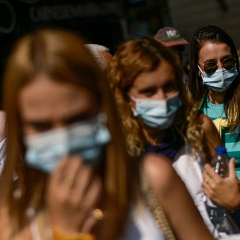 People wearing face masks to prevent the spread of