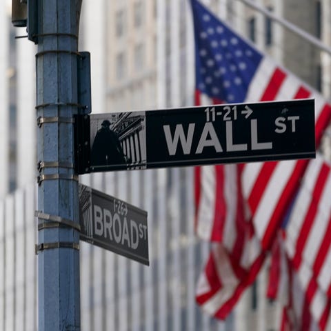 FILE - The Wall St. street sign is framed by the A