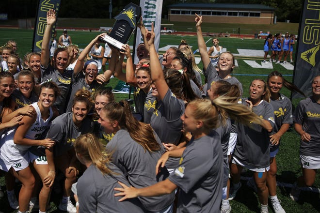 The Jacksonville University women's lacrosse team celebrates their win over the Liberty Flames of the ASUN Conference Championship on Saturday at JU's Jacksonville University's Rock Stadium. JU beat Liberty 20-12.