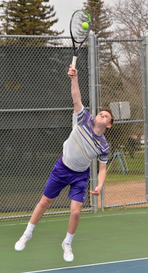 Watertown's Mark Mahowald serves the ball Friday during a high school boys tennis dual against Mitchell at the Highland Park Courts.  Mitchell won 7-2.