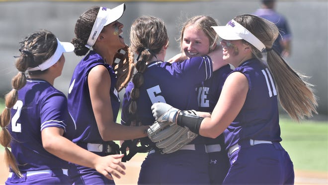 Wylie players celebrate with pitcher Rylee Moore, near right, after Moore got the final out in the Lady Bulldogs' 7-3 victory over El Paso Chapin in Game 2 of the Region I-5A area playoff series Saturday in Odessa. The win gave Wylie a sweep of the series.