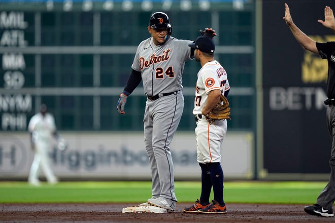 The Tigers' Miguel Cabrera taps Houston Astros second baseman Jose Altuve, 27, on the head after he scored in the third inning on Saturday, the 7th. It was Cabrera's 600th career double.