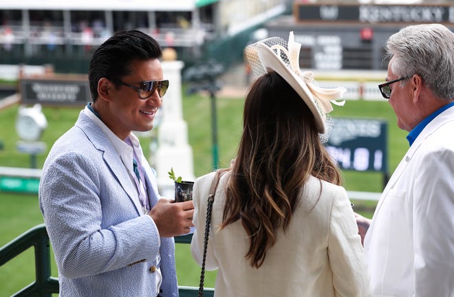 Actor Mario Lopez, left, chats on the balcony of the Millionaires Row at Churchill Downs in Louisville, Kentucky on May 7, 2022.  