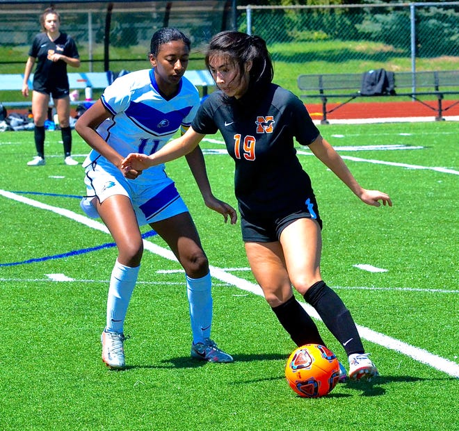 Northville's Emily Takahashi (right) moves the ball past White Lake Lakeland's Zeena Ahmed during a non-conference girls soccer game on Saturday, May 7, 2022.