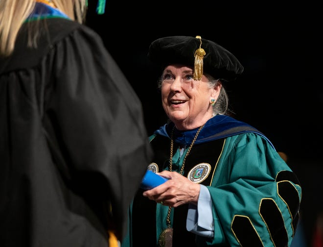 UWF President Martha Saunders hands out diplomas during the university's spring commencement May 7 at the Pensacola Bay Center.