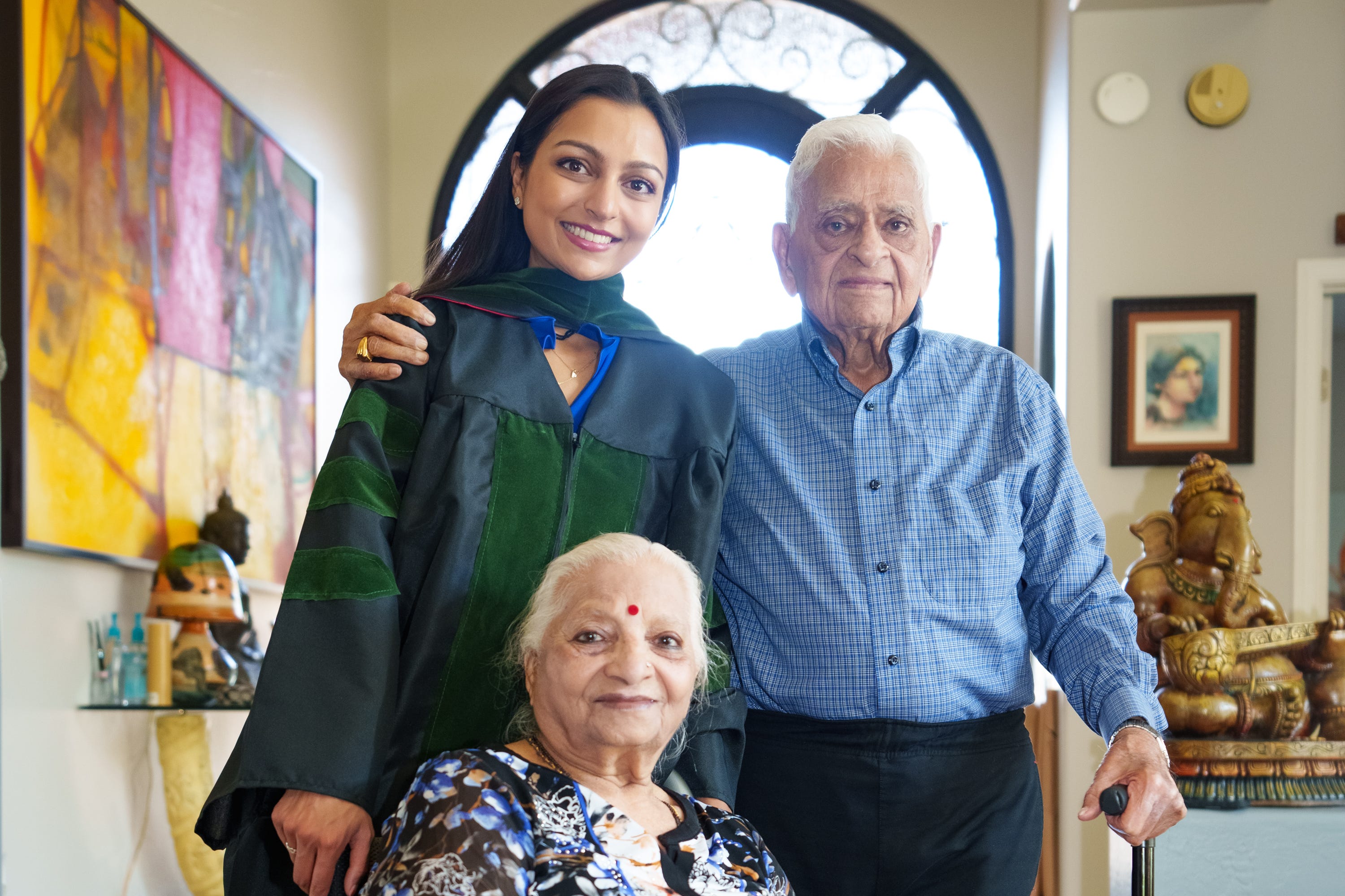 Graduate of University of Arizona's Phoenix medical school, Maya Patel (left), poses for a photo with her grandparents Bhaichand Dholakia (right) and Pushpaben Dholakia (front) in her home in Scottsdale on May 7, 2022.