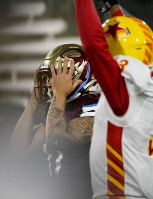 Michigan Panthers kicker Michael Carrizosa holds his hands to his head after missing the game-winning field goal against the Philadelphia Stars.
