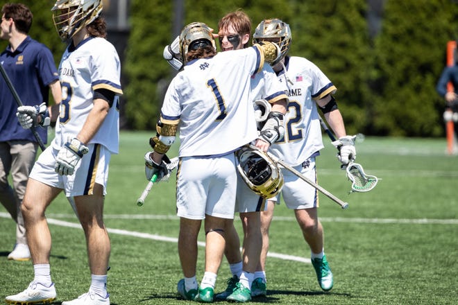 Notre Dame players Chris Kavanagh (50) and Jeffery Ricciardelli (1) celebrate victory after the Duke-Notre Dame lacrosse match on Saturday, May 07, 2022, at Arlotta Stadium in South Bend, Indiana.
