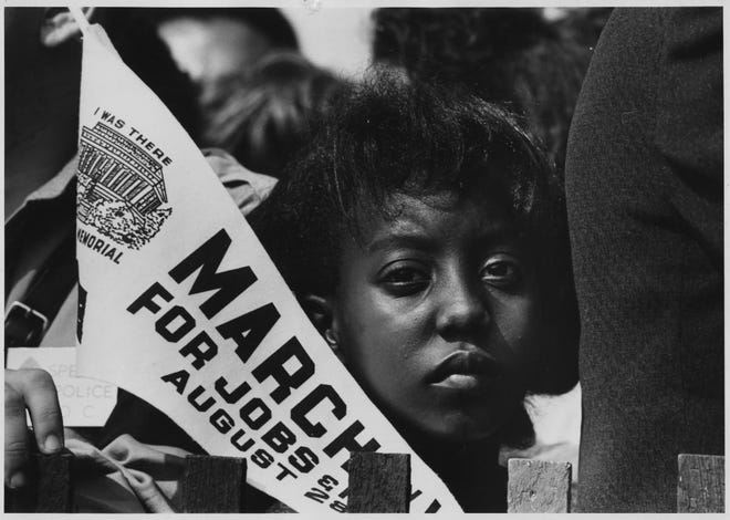 A woman holds a banner at the March On Washington.