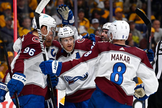 Avalanche center Nathan MacKinnon (29) celebrates with teammates after scoring a goal against the Predators during the first period in Game 3 on Saturday in Nashville.
