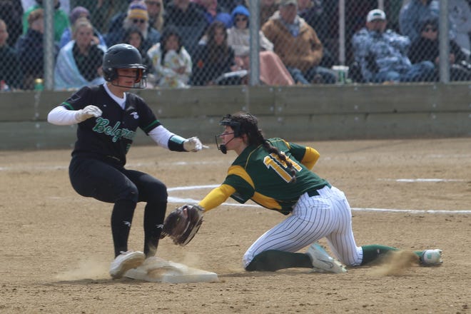 C.M. Russell shortstop Lauren Lindseth (14) goes for the swipe tag on Belgrade's Tycelee Bowler during Saturday's Eastern AA game at MultiSports. Bowler stole the base and Belgrade would win the game, 12-7.