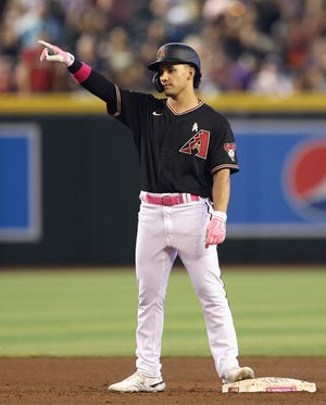 Alek Thomas #5 of the Arizona Diamondbacks reacts after his first career hit during the fifth inning of the MLB game against the Colorado Rockies at Chase Field on May 08, 2022 in Phoenix, Arizona