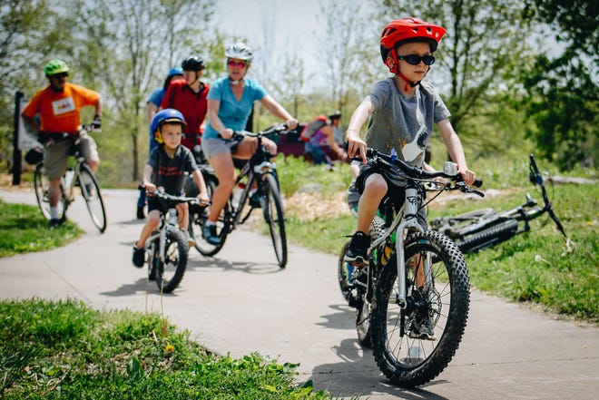 Families take off on a two-mile bike ride as part of Local Motion's Mother's Day event Sunday in Stephens Lake Park.