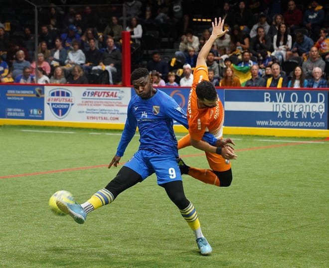 Florida Tropics midfielder Antony Arico challenges San Diego's Tavoy Morgan for the ball during a Major Arena Soccer League championship game in San Diego Sunday.