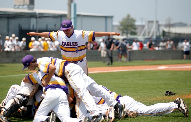 Red Oak players celebrate winning the Class A state baseball championship over Canute on Monday in Shawnee.