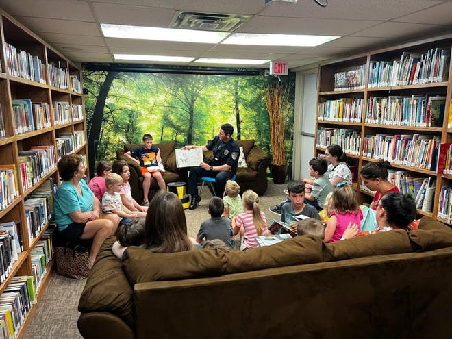 Officer Pittaway with the Stephenville Police Department reads to youngsters on May 7 as part of the Books with the Blue program at the Stephenville Public Library.
