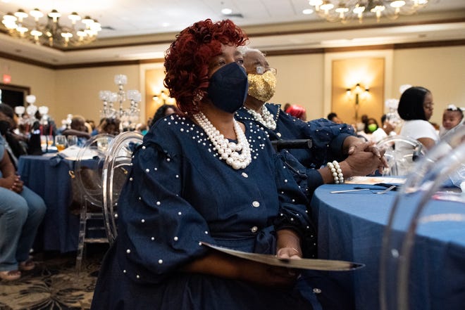Senior Pastor Margaret Dennison of Compassionate Outreach Ministries listens intently to the words of the speakers during the church's "Denim and Pearls Mother Daughter Luncheon" at the Best Western Gateway Grand Hotel in Gainesville on Saturday.