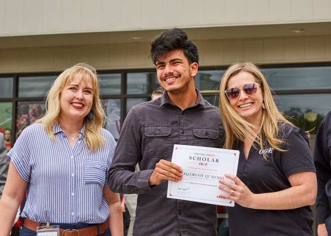 Qureshi smiles next to Lindsay Laird, an OGE representative and Northside High School faculty.