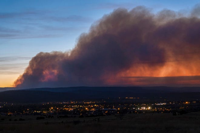 Smoke from the Calf Canyon/Hermits Peak Fire drifts over Las Vegas, N.M., on Saturday, May 7, 2022.