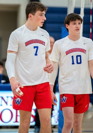Winnacunnet juniors Joshua Schaake, left, and Jack Andrews share a moment during a break in the action at a recent Division I volleyball game.