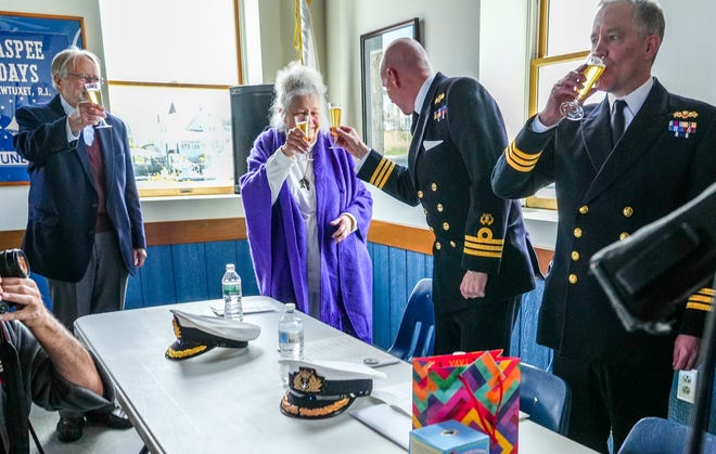 D.K. Abbass toasts the planned search for remains of the HMS Gaspee at Tuesday's event with Royal Navy Commanders Steve White, left, and Simon Rogers.