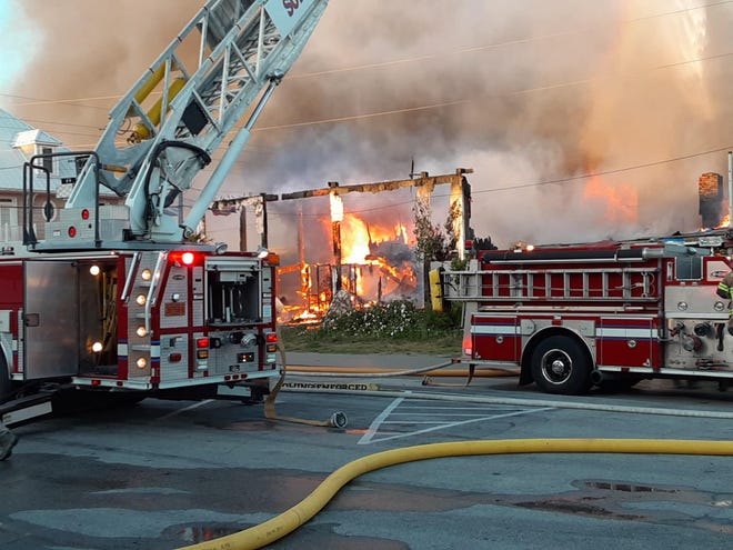 Fire crews battle a blaze at the old Blizzard's Motel on North Shore Drive in Surf City on Tuesday, May 10, 2022.