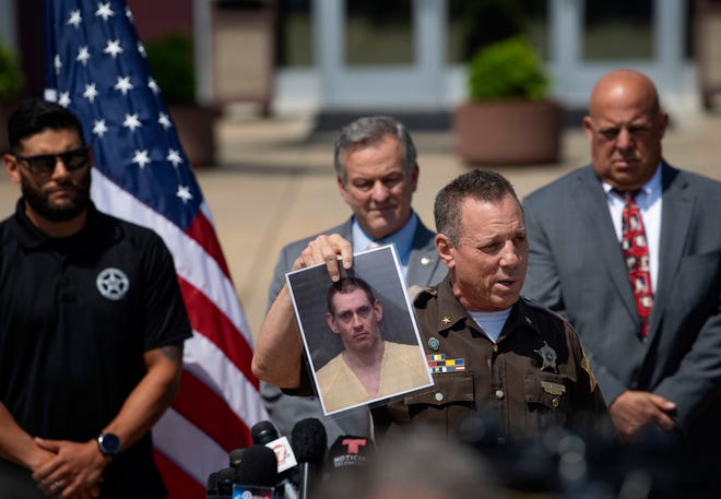 Sheriff Dave Wedding displays Casey White's reservation photo during a news conference at the Vanderburgh County Sheriff's Office on Tuesday.