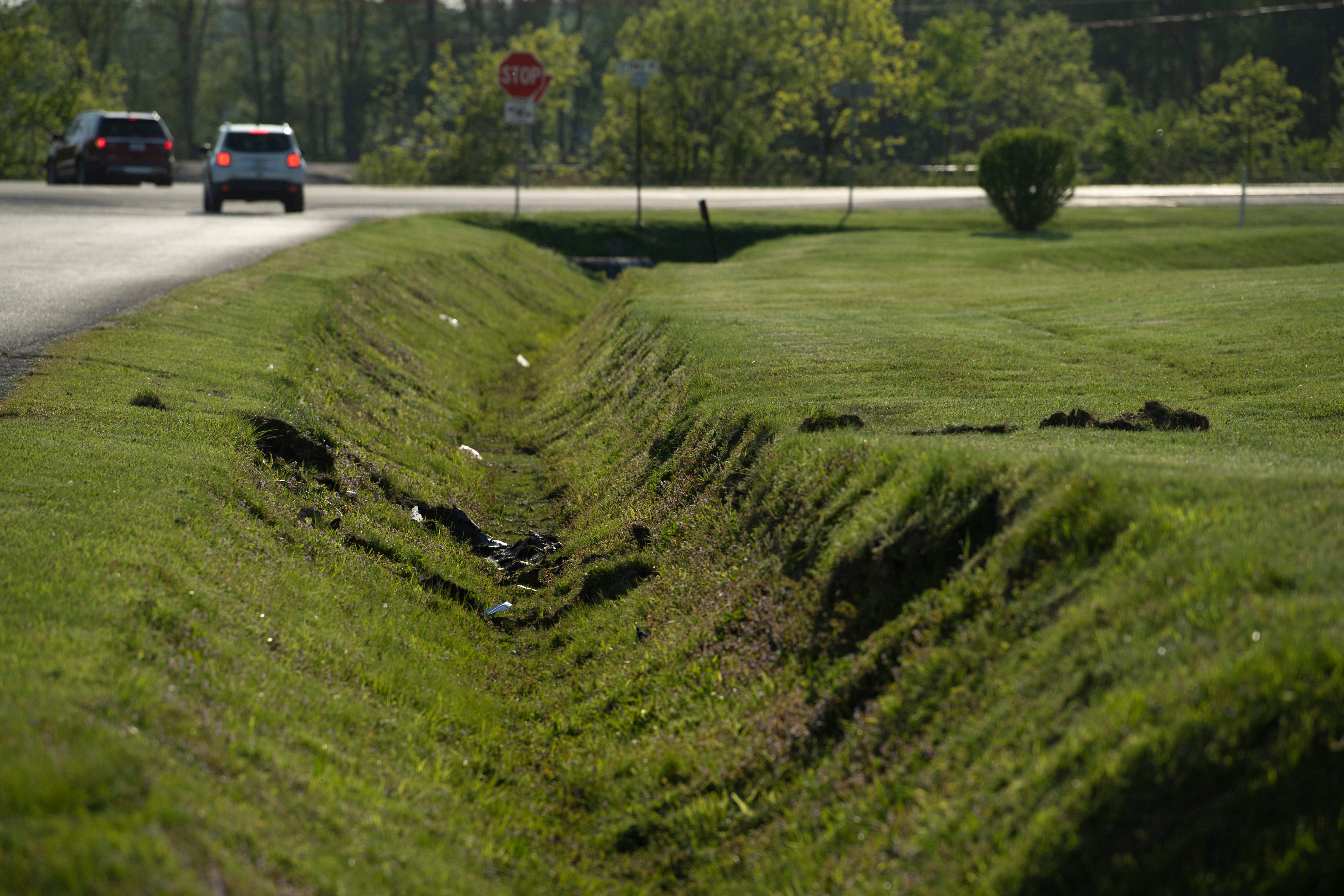 Muddy tracks mark the spot where the Cadillac sedan fugitives Casey White and Vicky White, no relation, were driving when law enforcement officials forced them into a ditch at Burch Drive in Evansville, Ind., after a short chase Monday evening, May 9, 2022. The two have been on the run since Vicky White, a detention officer, helped the inmate Casey White escape the Lauderdale County Detention Center April 28, 2022.