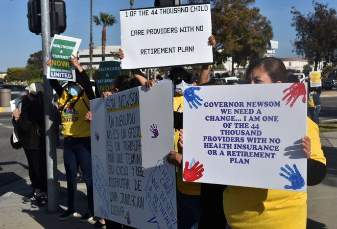 Child care providers send a message to state leaders in a demonstration in Oxnard on Monday.