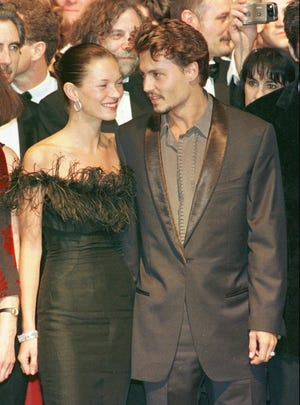 Johnny Depp arrives with model Kate Moss at the Festival palace in Cannes on May 15, 1998, to attend the screening of "Fear and Loathing in Las Vegas" in which he stars.