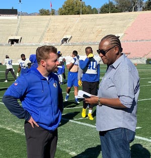 Jarrett Bell speaks with Rams coach Sean McVay during a Super Bowl week practice.