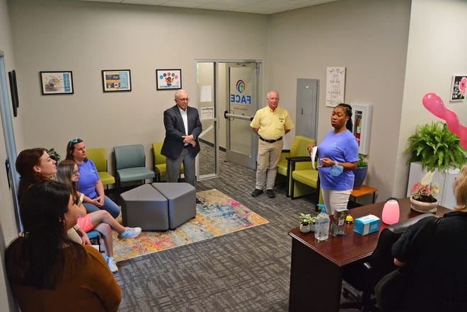 ShaVon Walls-Taylor, right, takes members of the public on a tour Tuesday of the new office space for Family Access Center of Excellence of Boone County, which is housed in the lower level of Boone County Family Resources on West Ash Street.
