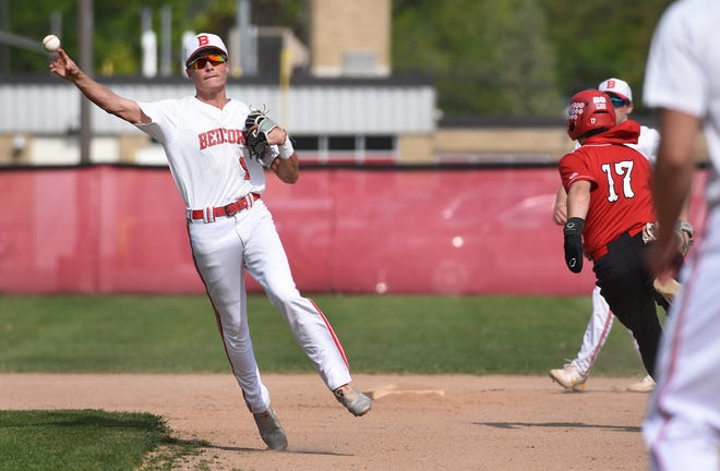 Shortstop Brendan Hammer of Bedford attempts a off balance throw  against Monroe earlier this season. The teams could meet again Saturday in the District finals.