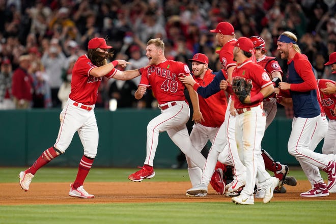 Los Angeles Angels starting pitcher Reid Detmers (48) celebrates with teammates after throwing a no hitter against the Tampa Bay Rays in Anaheim, Calif., Tuesday, May 10, 2022. Detmers graduated from Glenwood High School in Chatham in 2017. The Angels won 12-0.