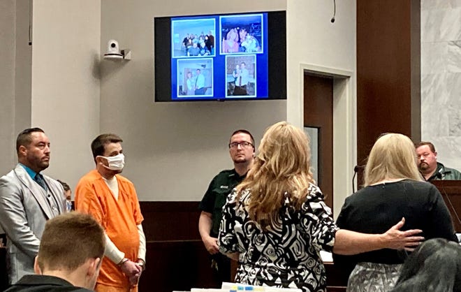 Cortney McKinney is comforted by victim advocate Lisa Lea Humpich as she tells Circuit Judge Register on Tuesday how the slaying of her father, Gordon McKinney, has affected her family's life. David Donaldson, in orange jumpsuit, was sentenced to life in prison for the 2020 murder of Gordon McKinney.