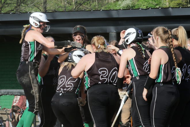 Clear Fork's Ashtynn Roberts (25) gets mobbed by teammates after her two-run home run in the Colts' tournament win over Norwalk on Tuesday.