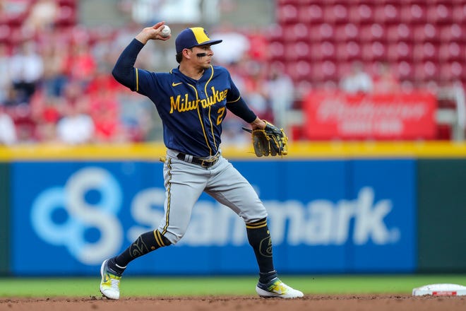 Brewers shortstop Luis Urias throws to first for an out Tuesday night against the Reds.