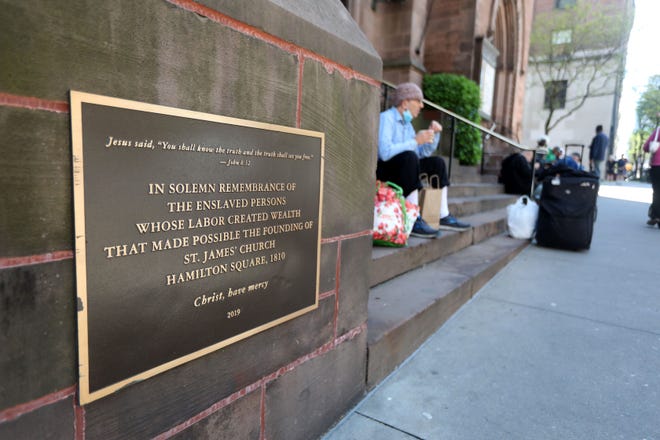 A plaque outside St. James Episcopal Church in Manhattan, photographed May 10, 2022, memorializes enslaved people who built Episcopal churches.  The Episcopal Diocese of New York has formed the committee to decide what reparations for slavery could look like.