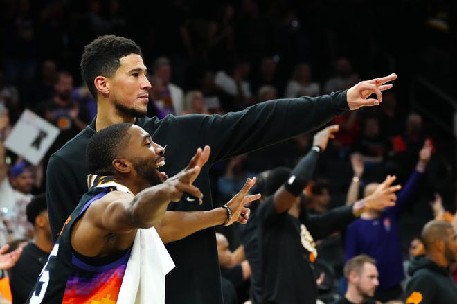 May 10, 2022;  Phoenix, Arizona;  USA;  Suns guard Devin Booker and forward Mikal Bridges celebrate a three-pointer against the Mavericks during game 5 of the second round of the Western Conference Playoffs.