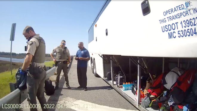 Body camera footage showing Liberty County deputies beginning their search of luggage belonging to the Delaware State University women's lacrosse team during a traffic stop late last month.  The team's bus driver (middle) talks to one of the officers.