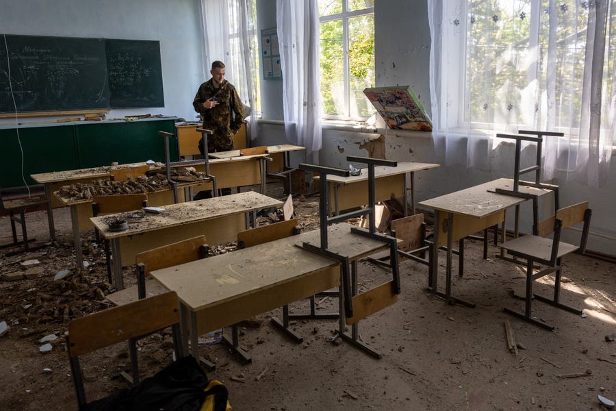 A soldier inspects a damaged classroom in a school on May 08, 2022 in Kochubeivka, Ukraine. Kherson Oblast fell to Russia shortly after the Feb. 24 invasion, as Russia sought to create an overland corridor from Crimea to separatist-held areas in the east. Most of Kherson Oblast remains Russian-occupied.
