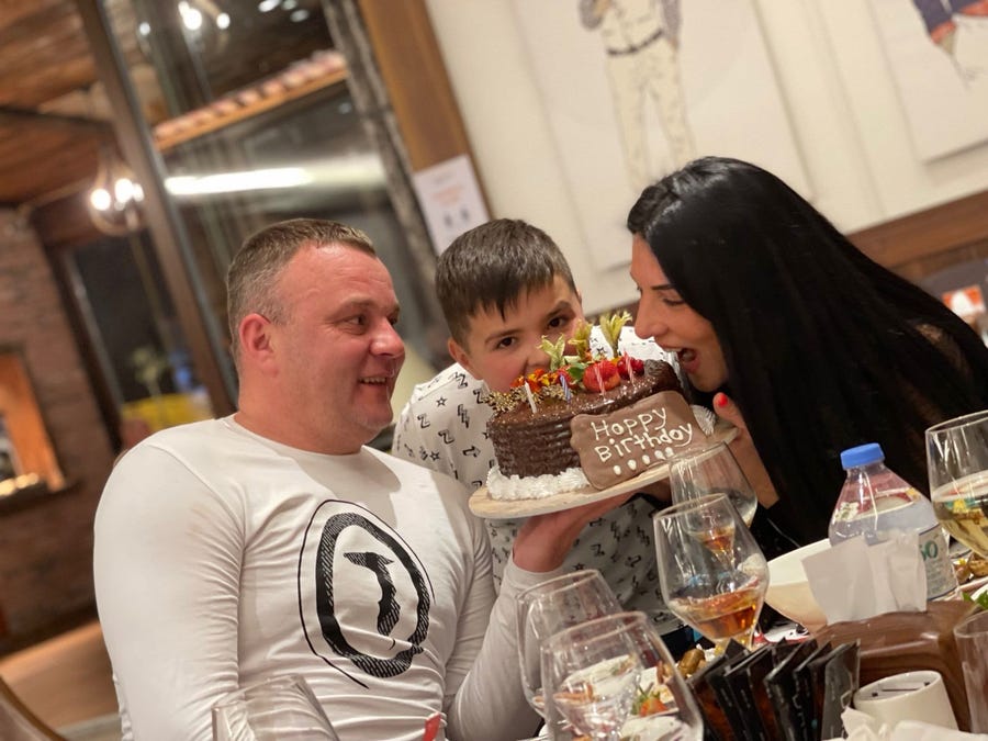 Egor and his parents celebrate a birthday. All were killed when a missile hit their home in Ukraine.