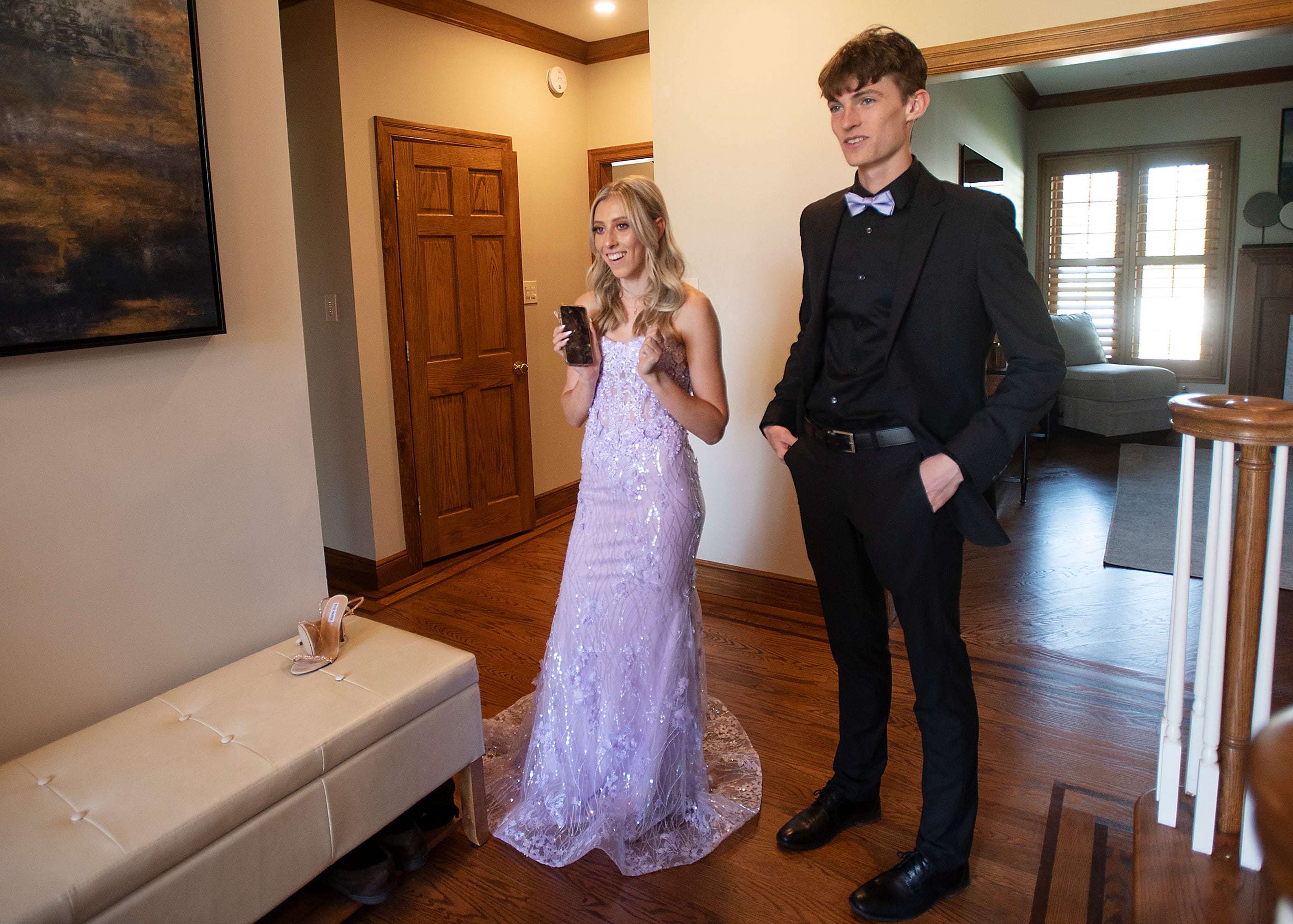 Mia Cochran waits for friends to arrive with her date, Krystof Purtell, at her family's Moon Township home before the Moon Area High School's prom on April 29, 2022.