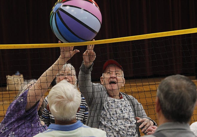 Dotti Hildreth and Walter Brenneman go after the ball during a chair volleyball game at the Evans Senior Center in Grove City on May 11. Chair volleyball is played at 1 p.m. Mondays and Wednesdays at the center, 4330 Dudley Ave.