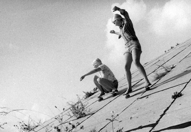 In 1977, Michelle Thibodeau, left, and Ellen Moomaw skateboard shoeless on the side of an Interstate 10 overpass near McDuff and Post streets, a section dubbed "The Wedge" after a dangerous surf spot in California. They were said to be the only two girls who could negotiate that portion of the concrete runway where broken glass and high weeds only added to the hazards.
