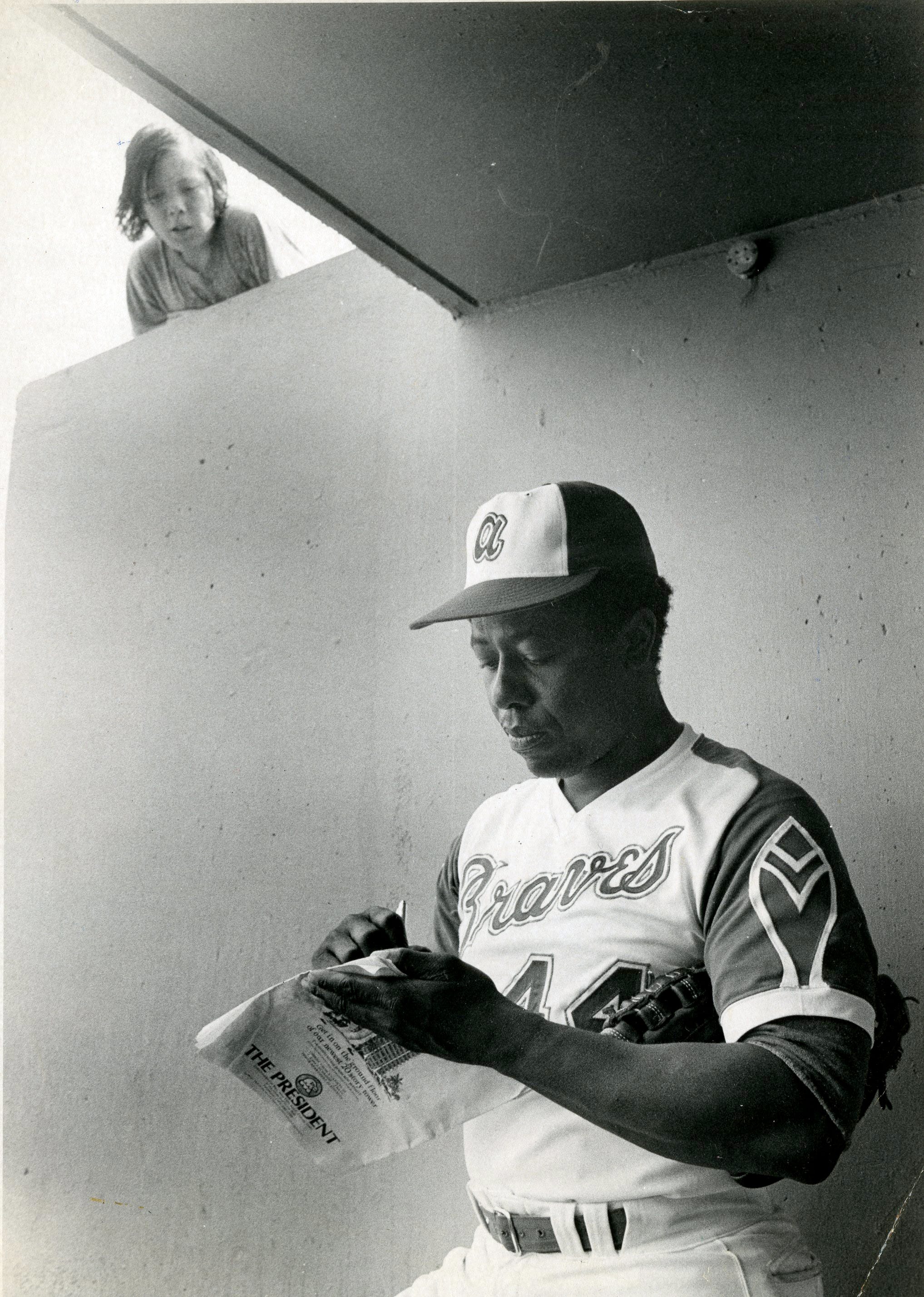 Hank Aaron signs for a fan at the old Municipal Stadium in West Palm Beach. Post file photo