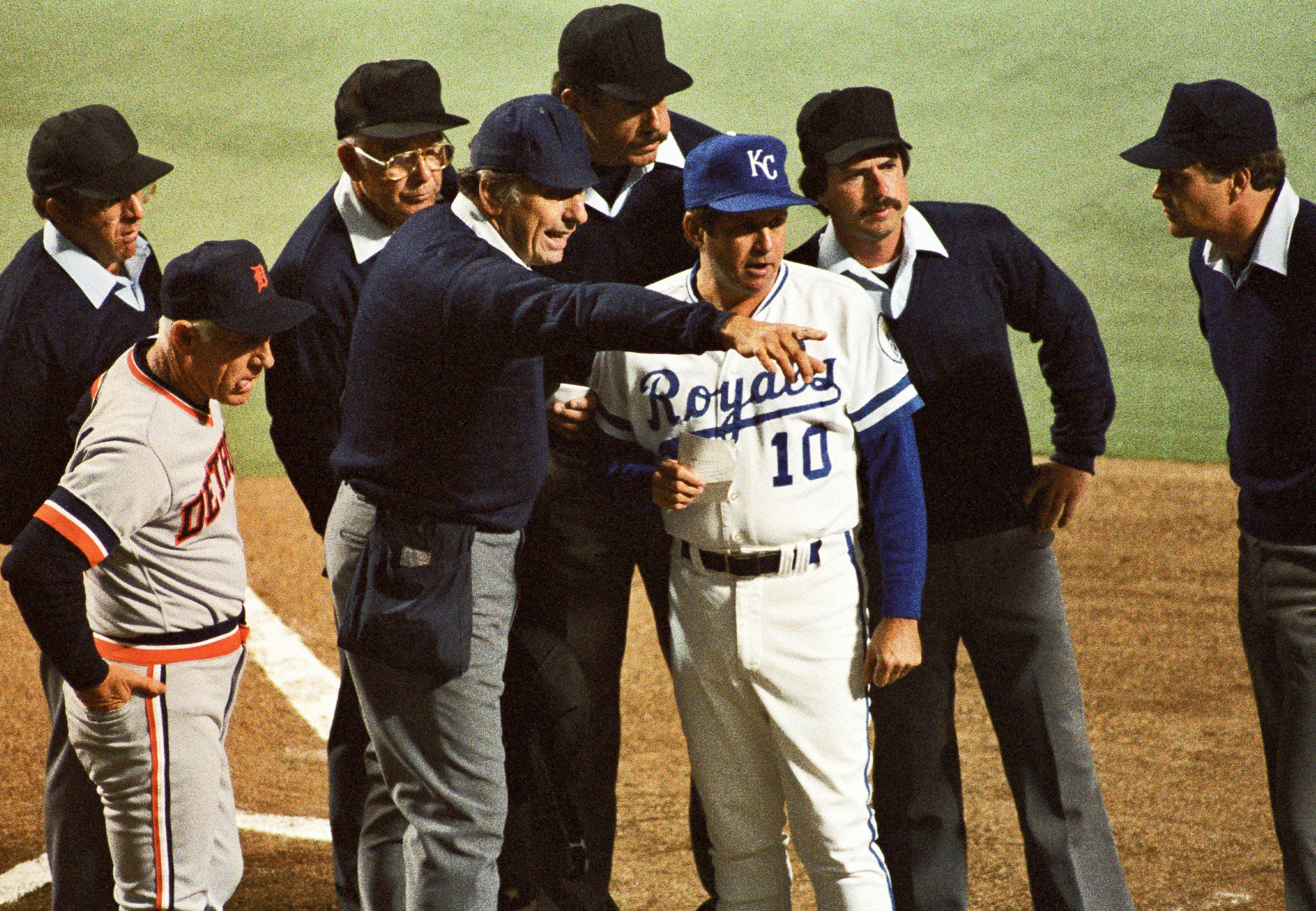 Royals manager Dick Howser and Tigers manager Sparky Anderson talk to the officiating crew during Game 2 of the 1984 ALCS at Royals Stadium.