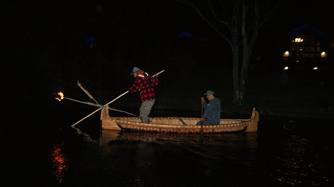 Wayne Valliere and his apprentice Lawrence Mann use a handmade birchbark canoe and other traditional gear to spearfish.