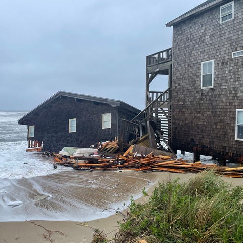 A collapsed house is seen along the shore in Rodan